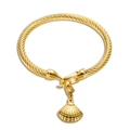 Golden twisted wire bracelet featuring a delicate shell charm in a minimalist style - Shell Pendant / Gold
