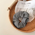 Houndstooth pattern hair scrunchie in black and white fabric on a rustic tray - Houndstooth Black