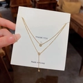 Collana a doppio strato in titanio dorato con ciondolo in cristallo su carta bianca - Nappa con Strass a Doppio Strato (X243) / Oro