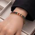 Detail of colorful rectangular zircon tennis bracelet with gold finish on wrist - Multicolor Large Rectangle