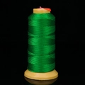 Spool of durable green nylon braided cord for jewelry making on a yellow reel - Grass Green