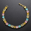 Detail of gold-plated brass bracelet with multi-color claw-set cubic zirconia stones - Gold Rainbow Zirconia Bracelet