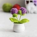 Handmade crochet potted plant with purple flowers in a minimalist white ceramic pot - Pine Cone Purple