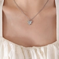 Silver heart pendant necklace with cat eye stone inlay worn by a model in close-up - Steel Color Heart Necklace Inlaid with Opal / Silver