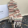 Detail of colorful plaid scarf with soft fringe tassels hanging on a wooden chair - Striped Beige