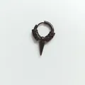 Detail macro of black stainless steel hoop earring with engraved pattern and spike pendant - Dragon Short Spike / Earring (Pierced) / Black