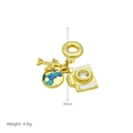 Detailed view of gold pendant with airplane, enamel globe, and camera charms - Airplane/Earth/Camera