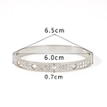 Detailed view of silver stainless steel bangle with diamond inlay and clover cut-outs - Silver Clover Style (NB-B6124-S)