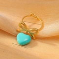 Anello dorato con fiocco e pendente a cuore turchese con fascia aperta regolabile - Taglia unica / Blu Lago