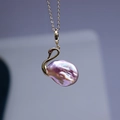 Swan pendant necklace featuring a purple baroque pearl and golden metal finishes - Iridescent Pendant With Chain And Box / Iridescent