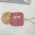 Detail of pink corduroy pouch with soft texture and green zipper drawstring for storage - Lotus Pink
