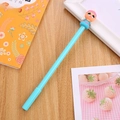 Sky blue cartoon gel pen featuring a pink-haired doll topper on a wooden desk - Blue Cute Princess