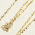 Macro shot of gold-plated cheetah pendant necklace encrusted with white zircon stones - Cheetah