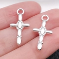 Pair of polished silver cross charms for DIY jewelry making on fingertip display - Spliced 23x12mm (1g)