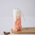 Creative Roman column candle with peach pink gradient and wavy texture on a wood base - Wave 5 (Pink)