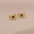 Golden double-layer bow earrings with emerald square stone on pink background - Gold Bow Green Zirconia / Green