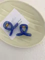 Detail of blue acrylic shark hair clips with gold metal springs on a ceramic tray - Mini Butterfly Clip X-Shaped (Approx. 4cm) / Translucent Royal Blue