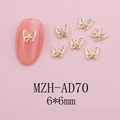 Detailed view of 6x6mm gold hollow butterfly nail charms on pink manicure tips - Gold Hollow Butterfly (AD70)