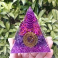 Purple crystal Orgone pyramid with golden Om symbol and copper coil held in hand - 8cm / 29 Purple Gold Gathering