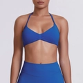 Close-up of royal blue seamless ribbed yoga bra with halter neck and ruching detail - Deep Sea Blue