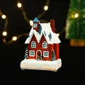 Detailed close-up of a glowing Christmas resin house with snow base and festive lights - Red Brick Blue Roof Building (Style 23-D)