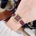 Women's square watch with gold case and deep wine red leather strap on a model's wrist - TT-Roman Numerals Dial