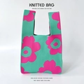Detail of vibrant flower pattern on green knitted tote bag with textured knit fabric - Green Rose Floral