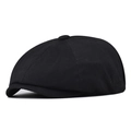 Detail of classic black cotton newsboy cap featuring eight-panel crown and top button - Black