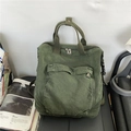 Dark green canvas backpack with large front pocket and retro industrial utility style - Green