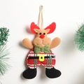 Handmade fabric reindeer Christmas tree ornament with green bow tie on a white wall - Plaid Reindeer