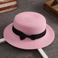 Pink straw sun hat with black bow ribbon and fine woven texture in flat top style - One Size / Pink