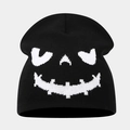 Close-up of black knitted beanie featuring white Halloween skull face jacquard texture - Style C Black+White (Laughing Ghost)
