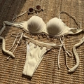 Close-up of cream ribbed bikini with 3D shell cups and hanging starfish charms on straw mat - S / Apricot