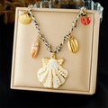 Fashion woven cord necklace with shell and starfish charms on a gold jewelry box - Pearl Shell Ladybug Pendant Style (N3684)