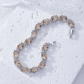 Close-up of champagne oval zircon tennis bracelet with silver-tone micro-pave setting - Oval Halo Style (B00331) / Champagne