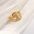 Detailed macro view of a gold hollow flower ring with zircons on white silk fabric - 18K Gold Plated Zirconia Flower