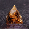 Orgone pyramid with yellow crystal stones and golden spiral wire on dark background - Sun - Sweet Love