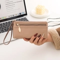 Detail of light khaki long wallet with leaf zipper and lychee grain leather texture - Apricot