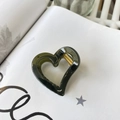 Close-up of heart-shaped dark green resin hair claw clip with golden metal spring - Approx 4.2cm / Translucent Grey Green