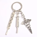 Medical keychain with silver thermometer, syringe, and Caduceus charm on white background - Style 7 (Caduceus Medical Symbol)