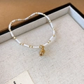 Elegant ethnic white bead bracelet featuring a delicate golden shell pendant charm - Conch Pendant Style (149) / White
