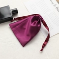 Elegant purple satin drawstring gift pouch with smooth silk texture and matching ribbons - Deep purple