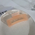 Translucent peach orange rectangle hair claw clip on a white ceramic plate - Square Glossy Pink