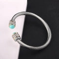 Detailed macro view of cable wire bangle featuring turquoise stones and crystal accents - Turquoise / Bohemian Style