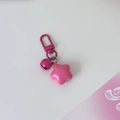Detail of pink star-shaped keychain with matching bell and durable D-ring clasp - Rose Red
