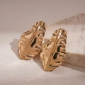 Detail of gold leaf earrings with textured hammered finish on marble background - Gold / Gold