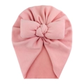 Detailed view of pink knitted baby turban hat with a large soft bow on white background - Pink