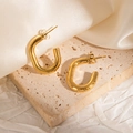 Detail of 18k gold plated chunky U-shaped hoop earrings on elegant textured stone background - Thick Smooth U-Shaped Earrings
