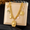 Detail of gold chain necklace with celestial sun, moon and star charms on a display stand - Sun Moon Pendant Necklace (N3600)