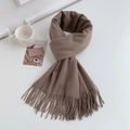 Flat lay of khaki faux cashmere scarf with fringes next to a mug on white surface - Regular Fit / Dark Camel